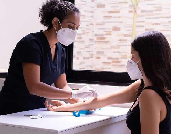 Nurse prepping patient's arm for a blood draw.